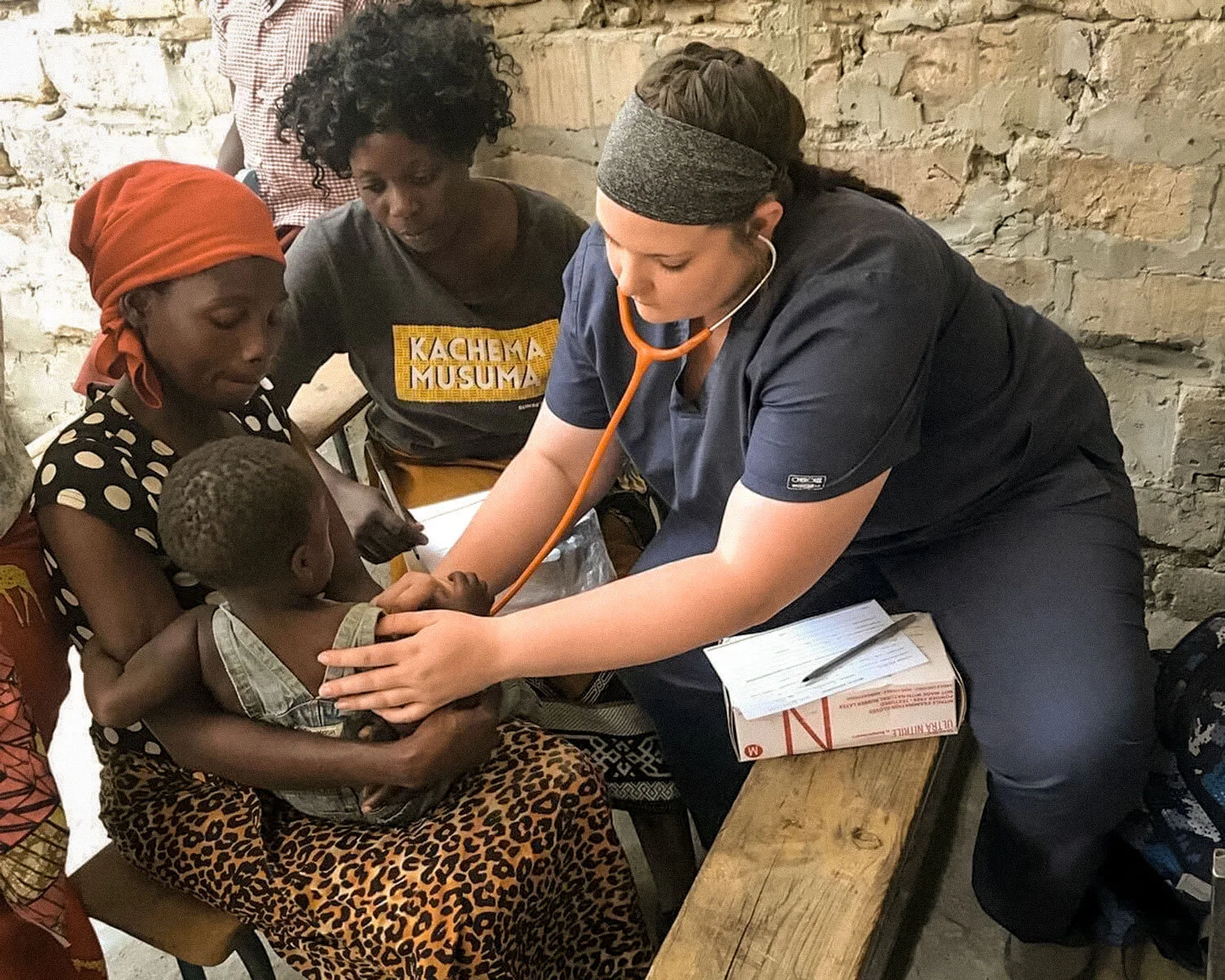  One of the team members checks the heart rate of a young boy who came to the clinic with his mother.  