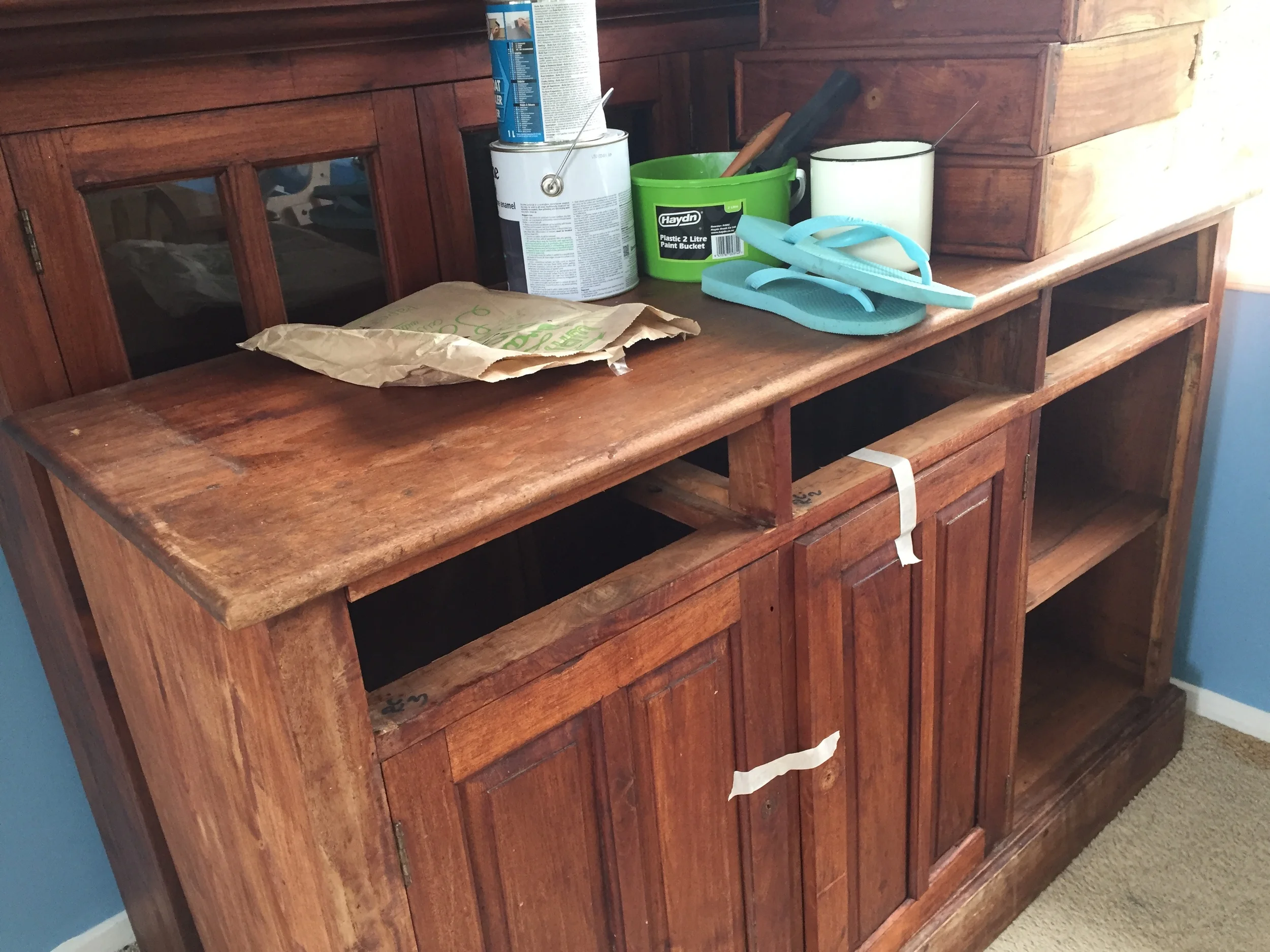 The dresser is in two parts - with the glass windowed top (behind) to sit on top of the base (front) unit.