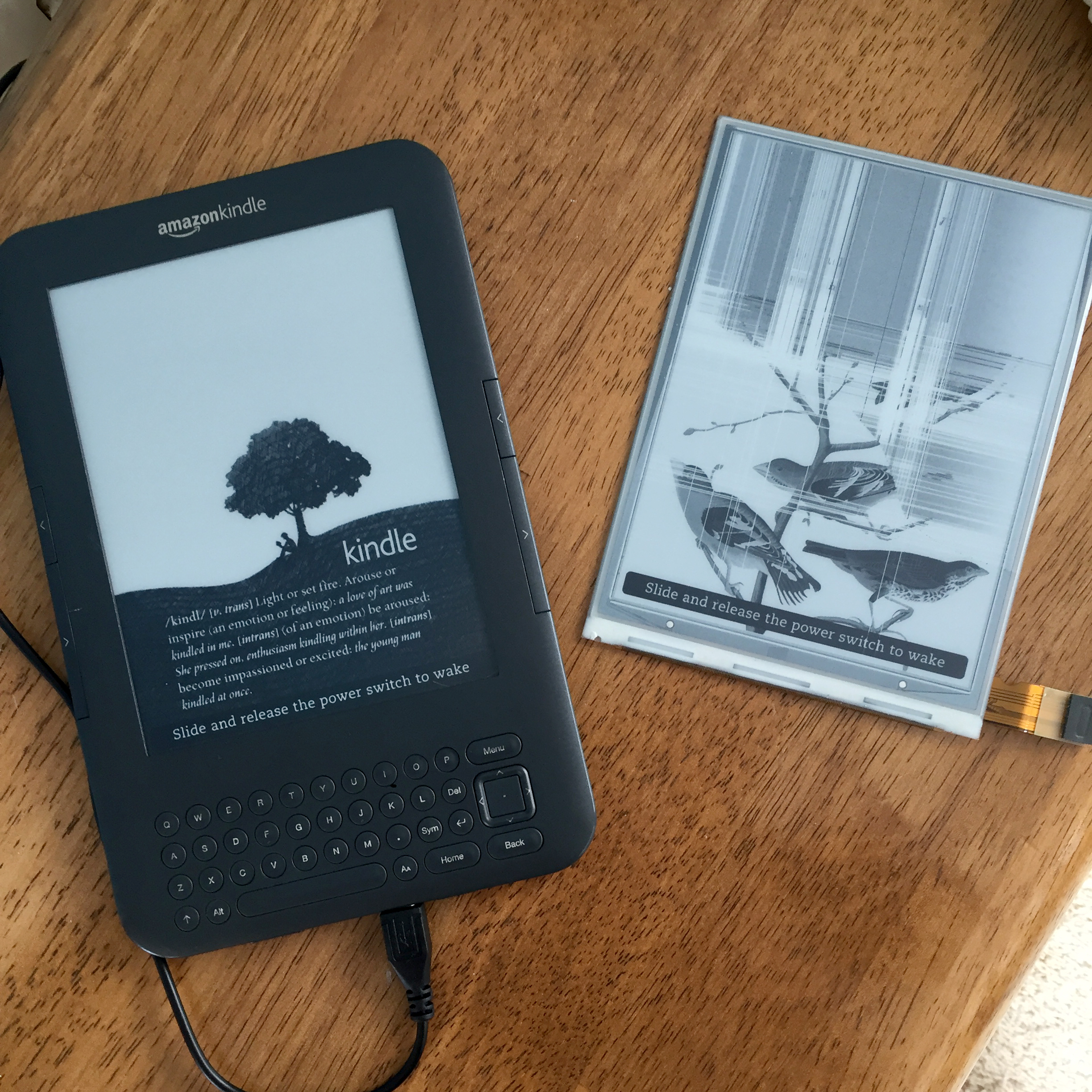 Kindle keyboard with new screen - broken screen on the right had a big crack down the back of it.