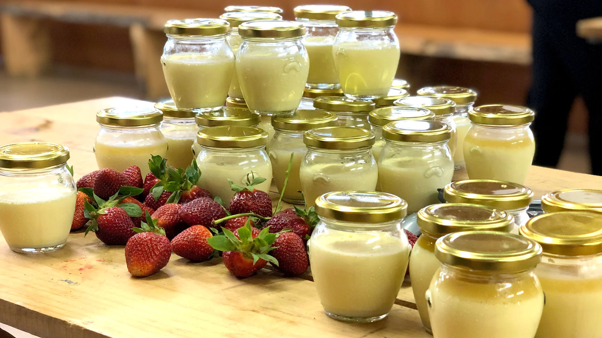Jars of vanilla panna cotta and strawberries