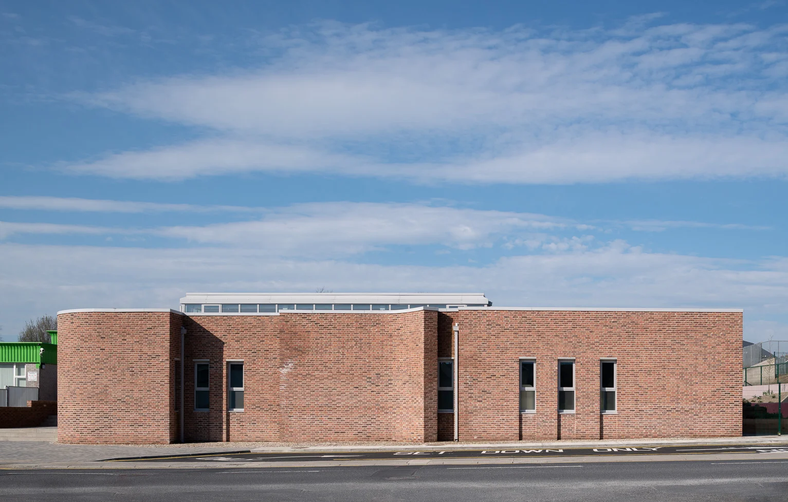 Street facade of curving handmade brick with lime mortar
