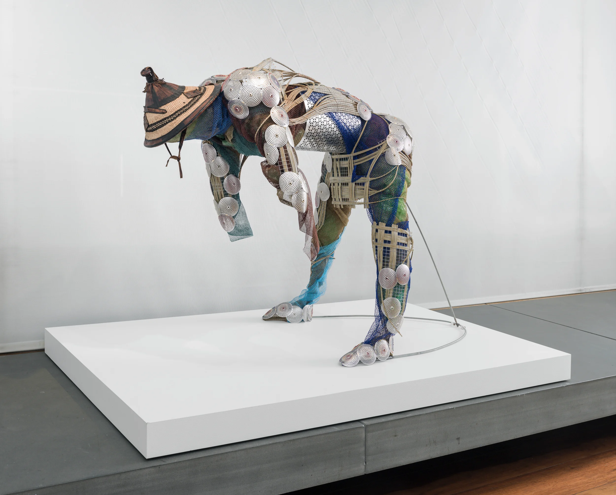 Past/Future, 2015, Adejoke Tugbiyele . Straw hat, palm stems, bathing nets, perforated metal, brass wire, and copper wire. Photo credit: Adam Reich.