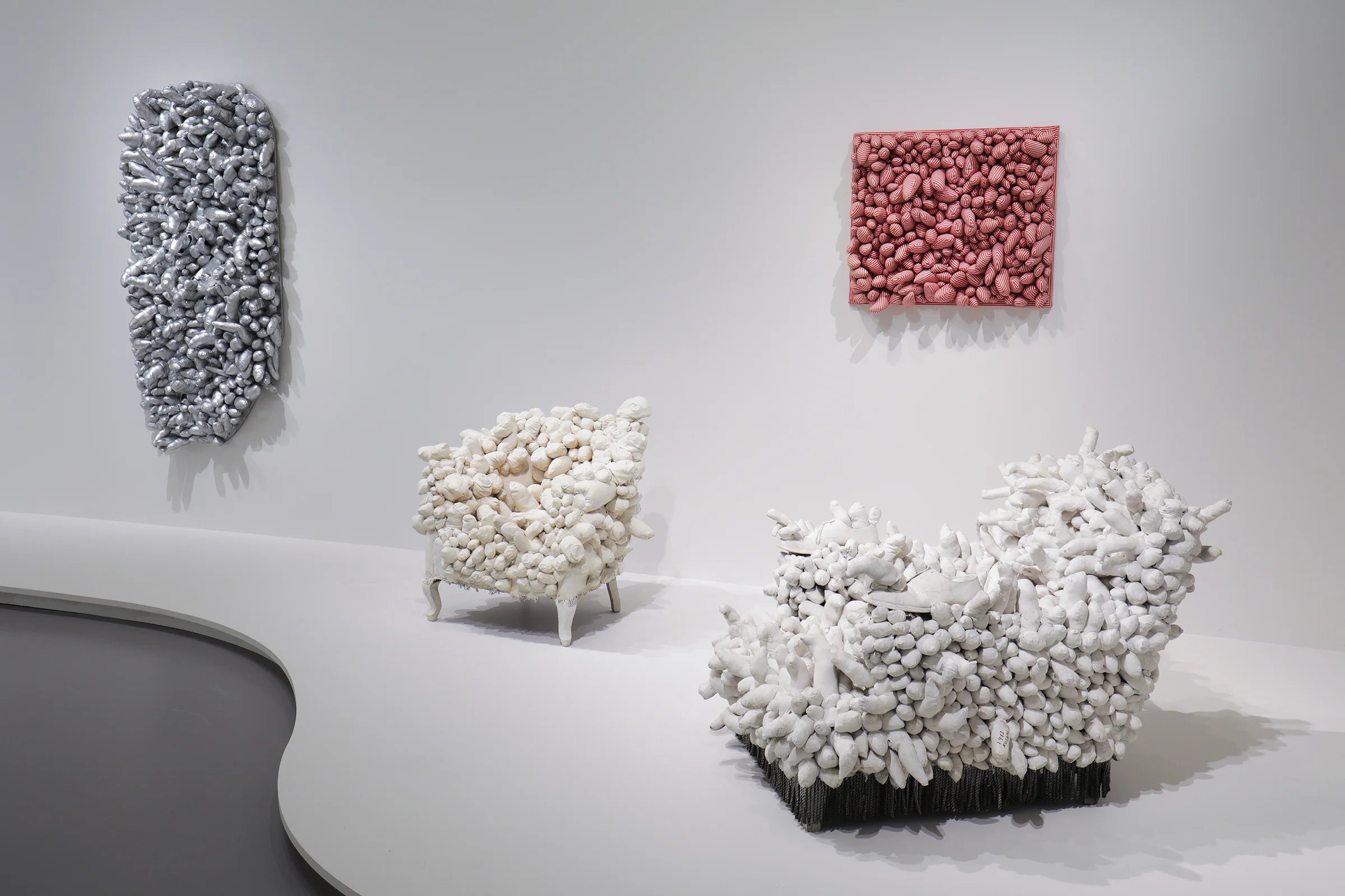 Installation view of Yayoi Kusama: Infinity Mirrors at the Hirshhorn Museum and Sculpture Garden, 2017. Left to right: Ennui, 1976; Accumulation, 1962-64; Red Stripes, 1965; Arm Chair, 1963 Photo by Cathy Carver