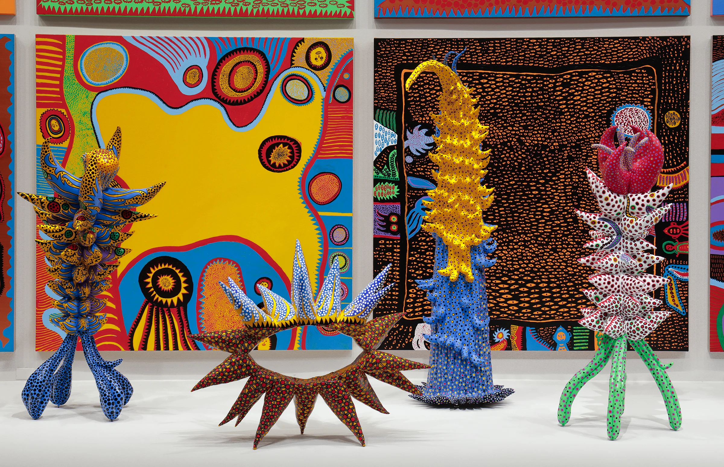 Installation view of Yayoi Kusama: Infinity Mirrors at the Hirshhorn Museum and Sculpture Garden, 2017 . Left to right: Living on the Yellow Land, 2015; My Adolescence in Bloom, 2014; Welcoming the Joyful Season, 2014; Surrounded by Heartbeats, 2014; Unfolding Buds, 2015; Story After Death, 2014. Photo by Cathy Carver