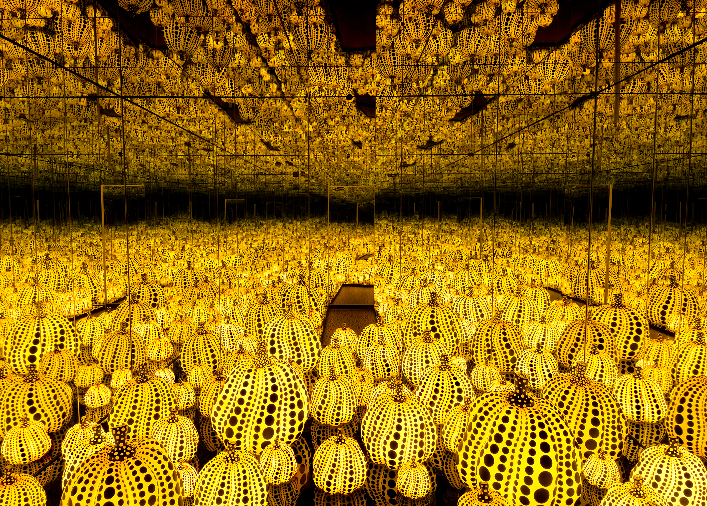 All the Eternal Love I Have for the Pumpkins , 2016, at the Hirshhorn Museum and Sculpture Garden Wood, mirror, plastic, black glass, LED Collection of the artist. Courtesy of Ota Fine Arts, Tokyo / Singapore and Victoria Miro, London. © Yayoi Kusama 