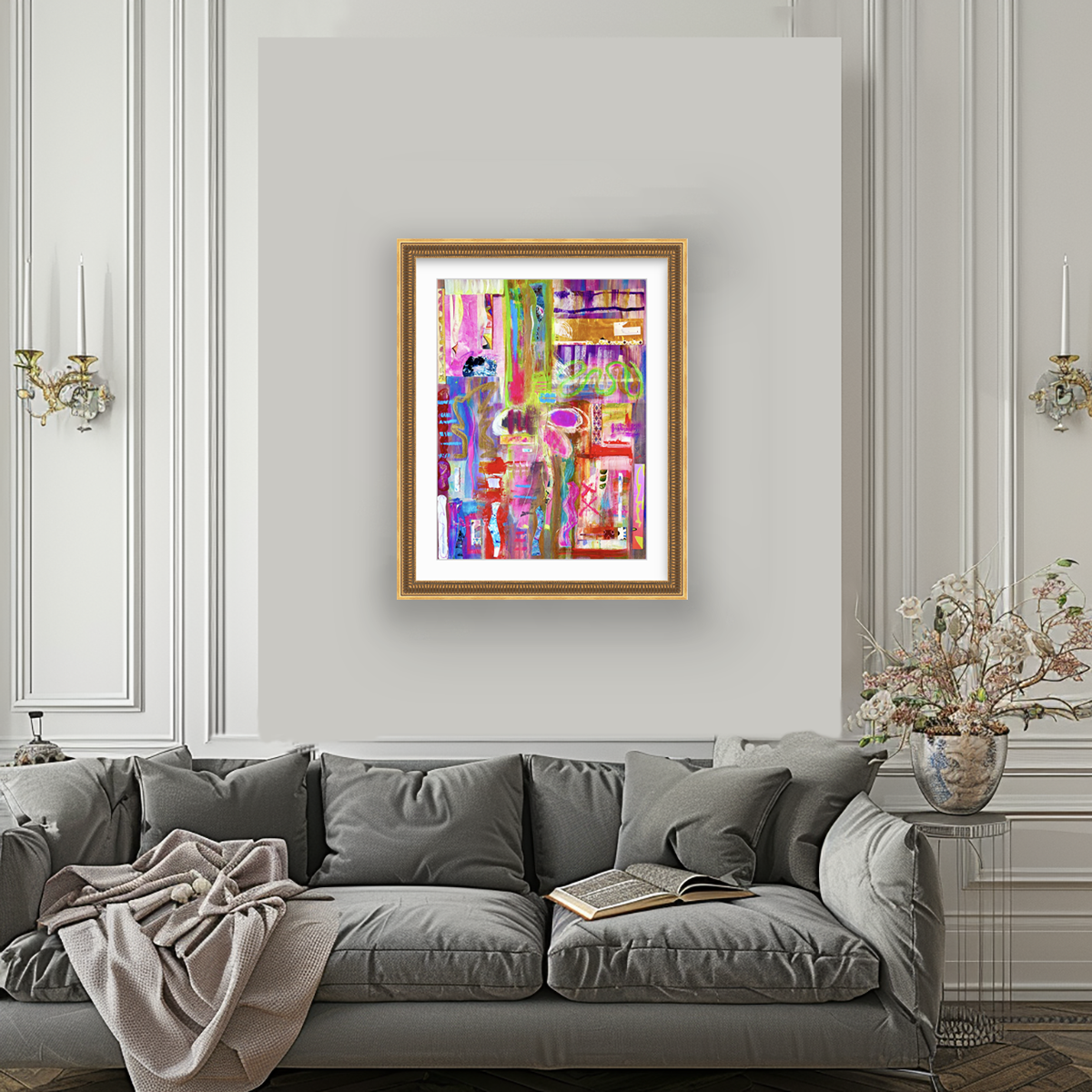 SMASH, mixed media collage in gold bead frame, hanging over grey sofa, by Ceil Diskin