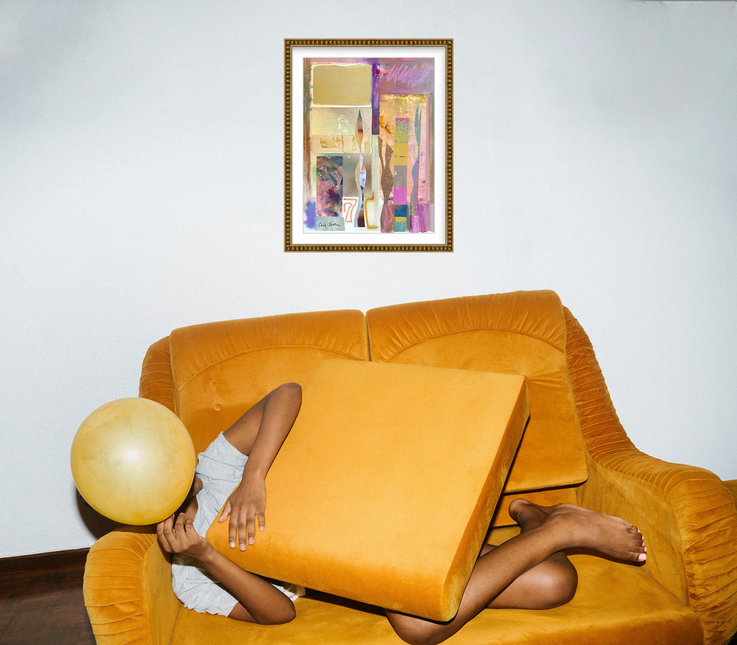 L'Ingenue, collage print in gold bead frame over orange sofa, by Ceil Diskin