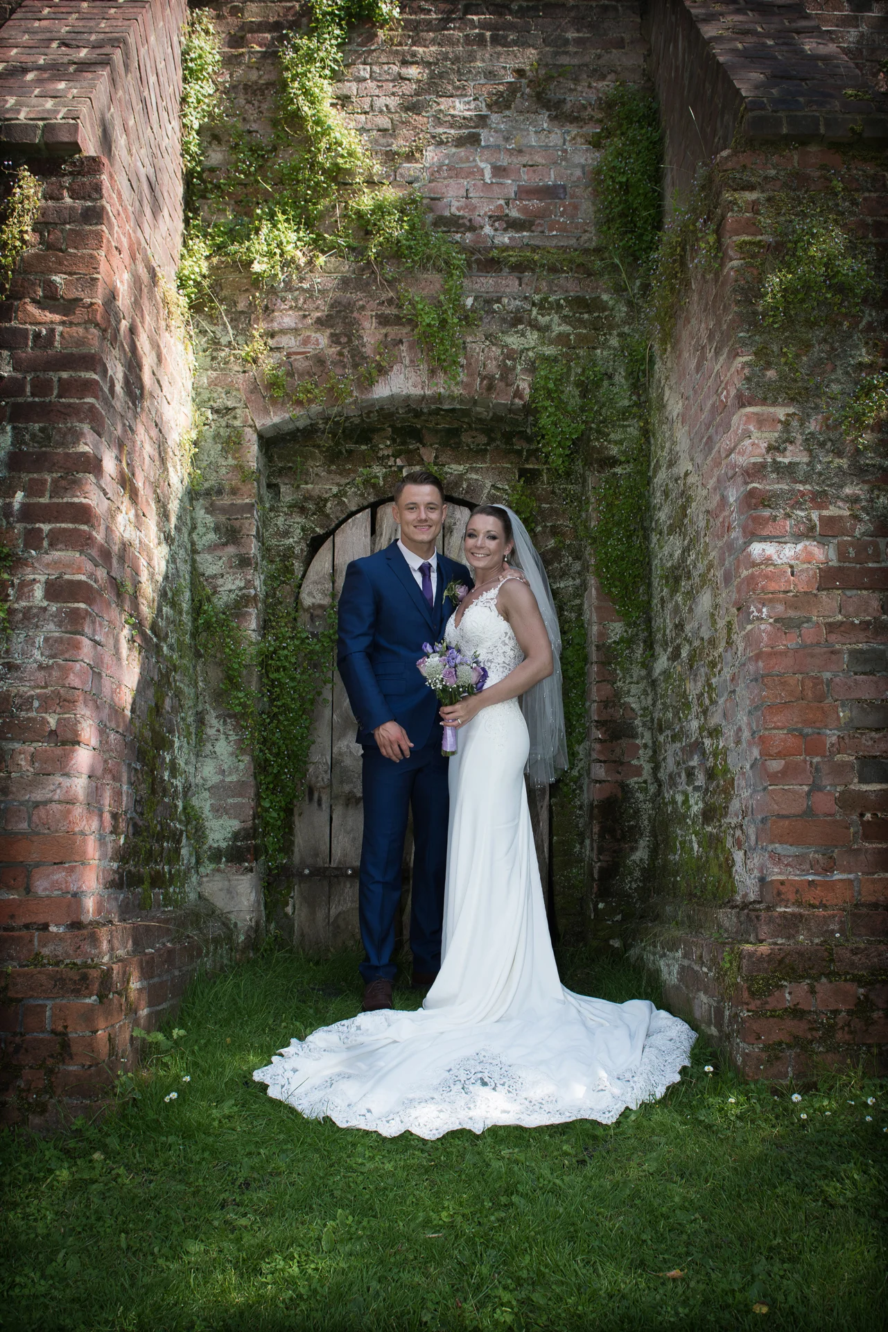 Bride & Groom pose at the Ufton Court garden wall