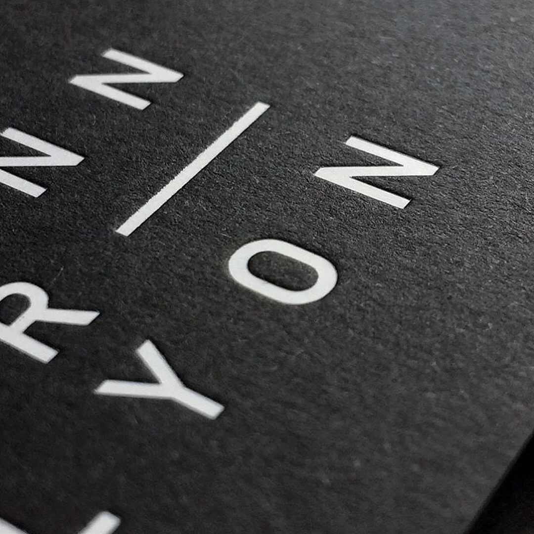 Black Paper Business Cards with White Foil Stamping and Deep Debossing