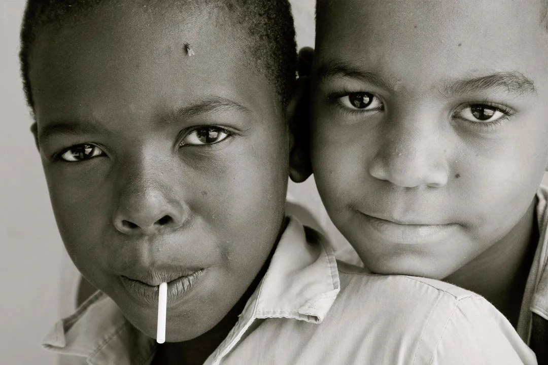 MANO GUYABO, DOMINICAN REPUBLIC - Two brothers wait outside a local school house. 