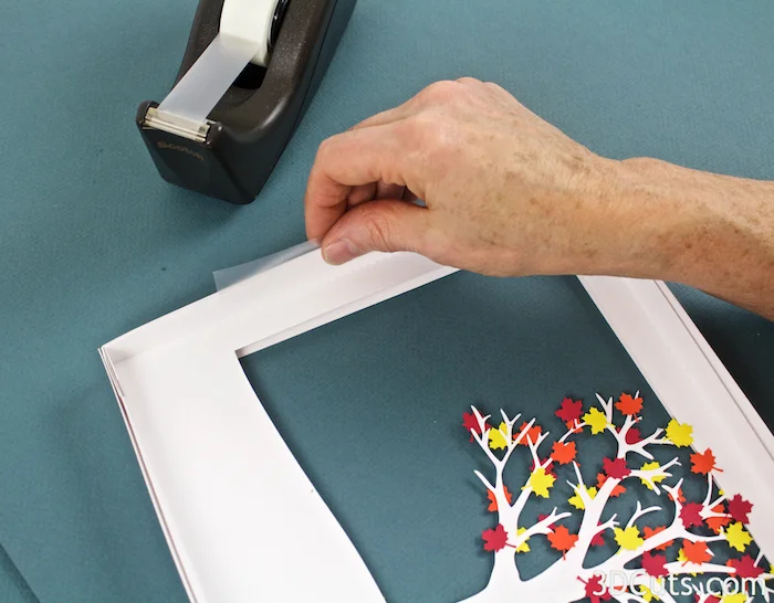 2. On the backside apply scotch tape to the inside edge, fold it over and tape the back edges together. Do this on all four sides. Be sure to keep the back edges aligned.