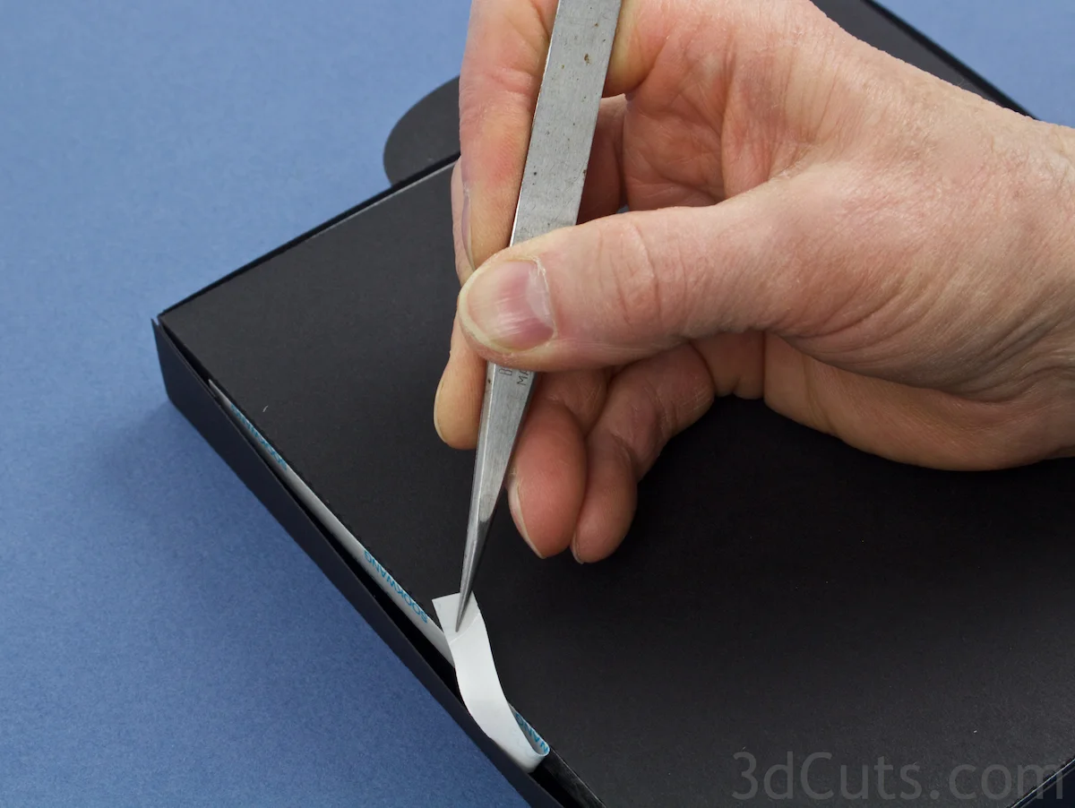 Use tweezers to remove backing and press sides in place.