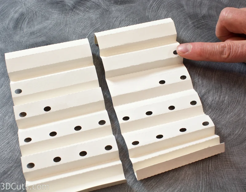 The two braces with holes need to be mirror images.