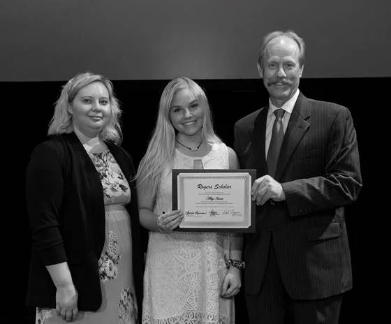 Lonnie Lawson, President and CEO of The Center for Rural Development, and Allison Cross, Community Liaison and Youth Programs Coordinator for The Center, present 2019 Rogers Scholars graduate Abby Isaacs with a certificate for completing the program. She is a junior at Garrard County High School.