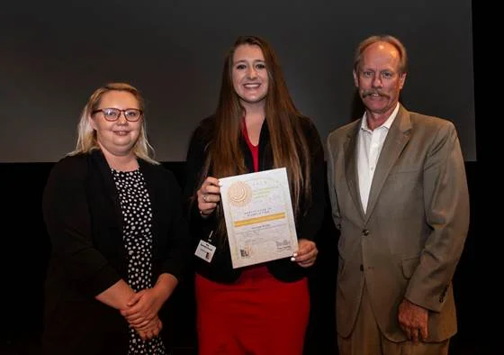 Lonnie Lawson, President and CEO of The Center for Rural Development, and Allison Cross, Community Liaison and Youth Programs Coordinator for The Center, present 2019 ELI graduate Kennedy Bruner with a certificate for completing the program. Bruner …