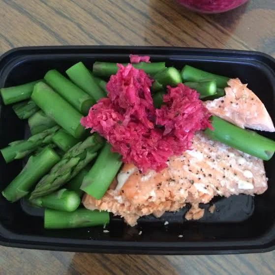 A meal in one of the ISO Bag containers . Asparagus, salmon and fermented red cabbage.