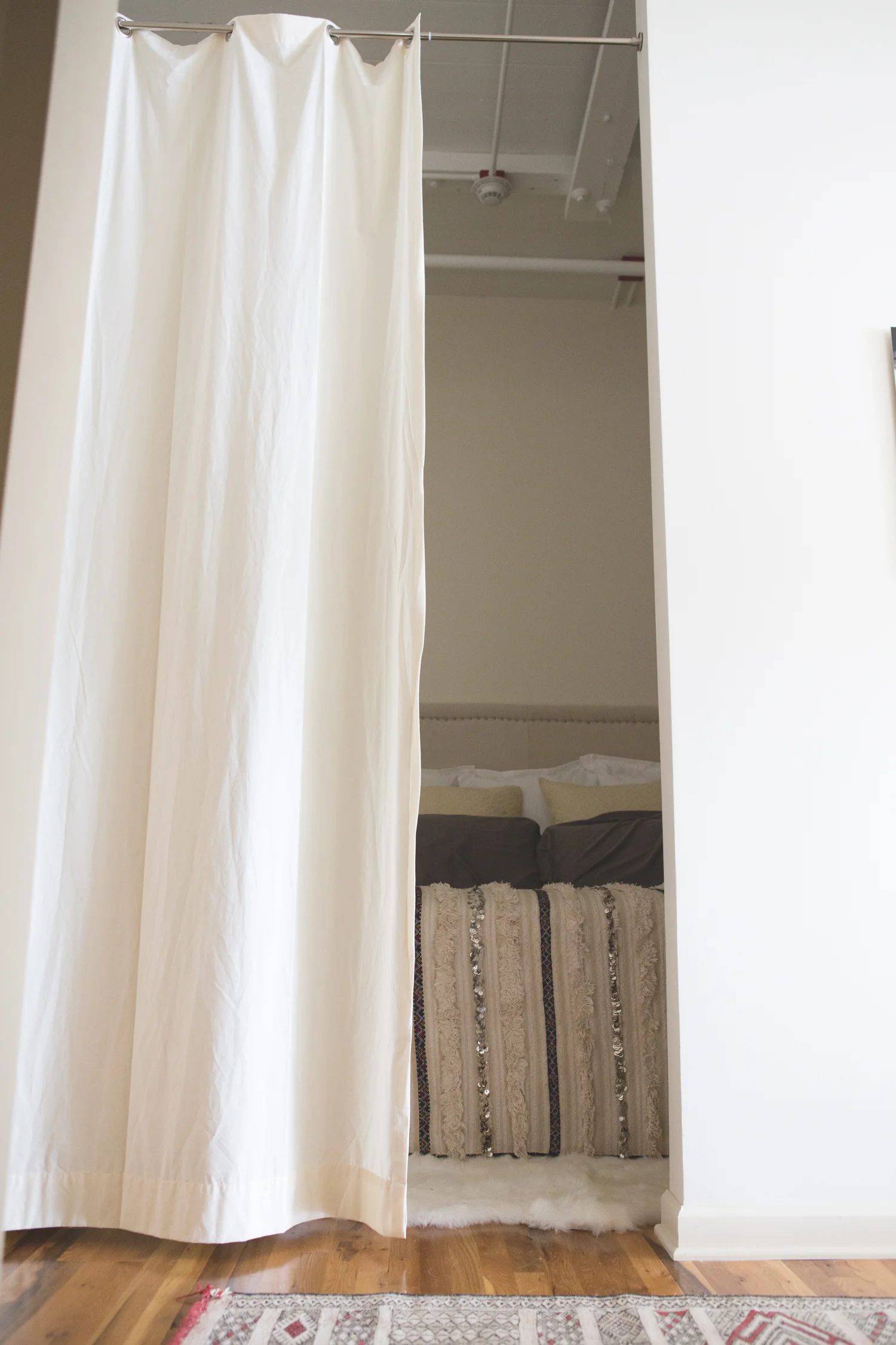 bedroom Room divider , diy headboard , rugs and blanket from Morocco, duvet cover & shams c/o - use coupon code Yogainbed for free shipping until 7/2/15, bed c/o.