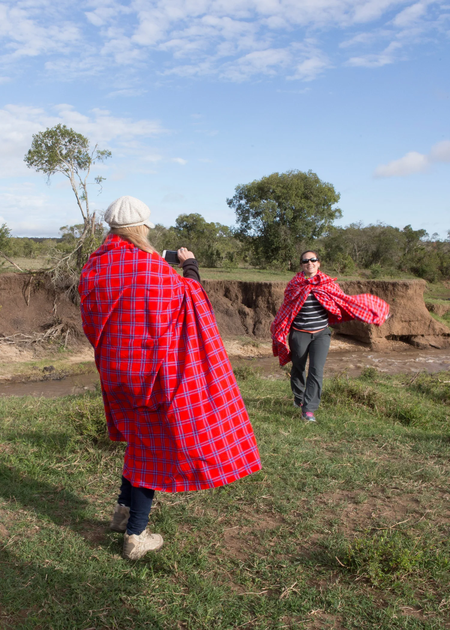 Two of our retreat goers snapping pics at breakfast wrapped in Massai blankets to keep warm
