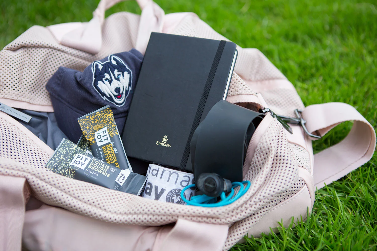 In my gym bag: FitJoy bars , Uconn hat , my workout notebook, a resistance band , headphones and Namaslay® goat tape