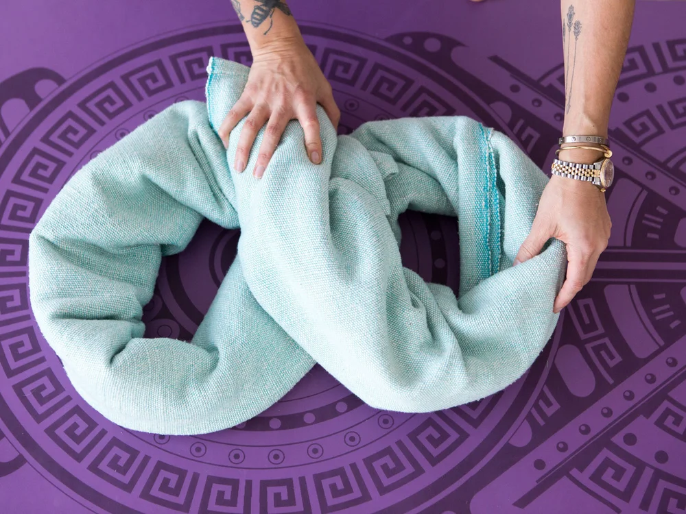 Step one - twist your yoga blanket into a figure eight.