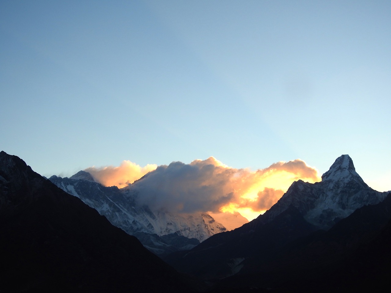 Mount Everest (left) at sunrise. Ama Dablam is on the right. Lhotse is hidden by clouds.