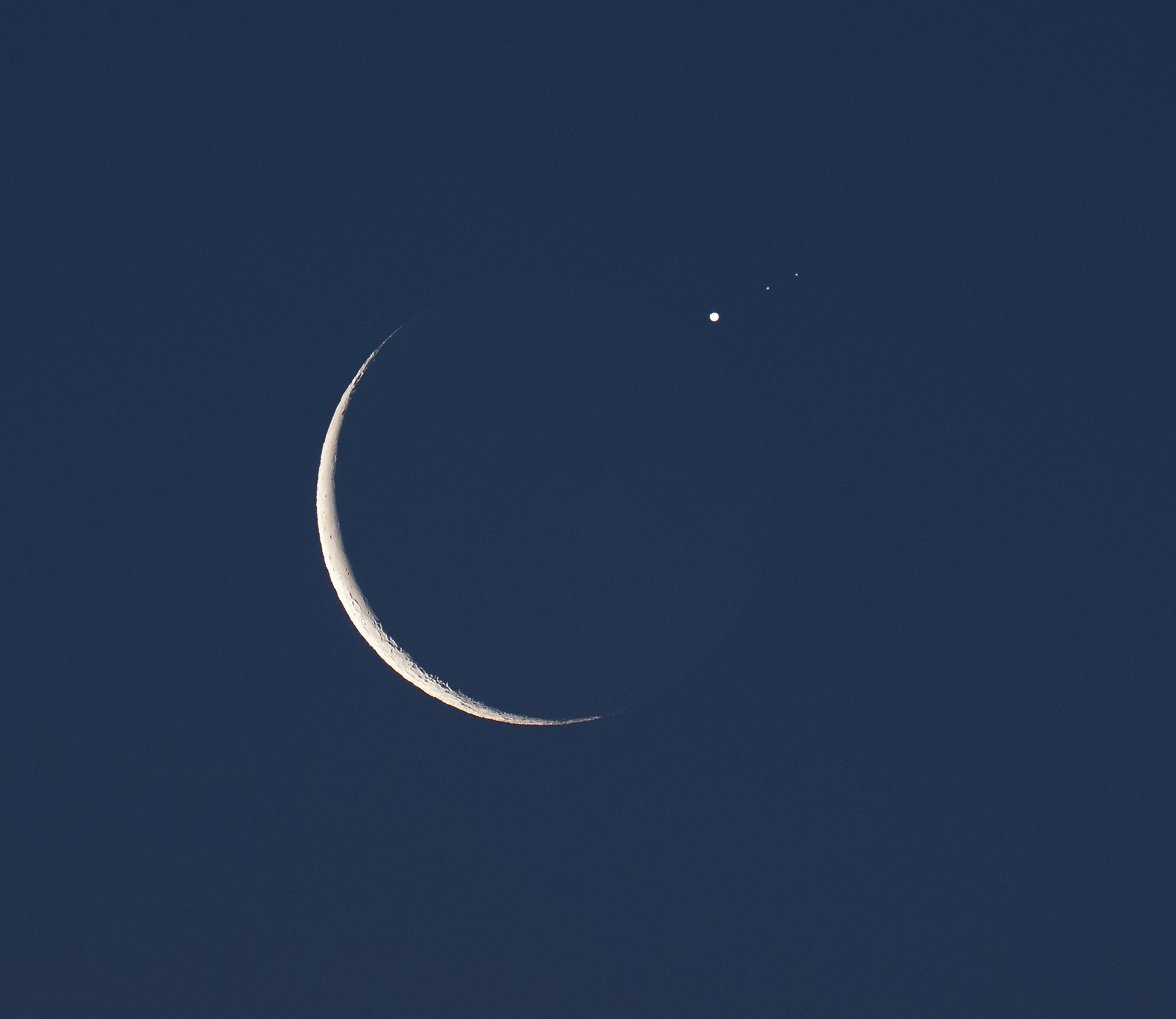 Jupiter reappearing from behind a nearly new moon