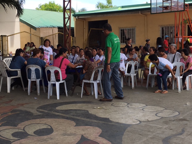 Both adults and children wait all day for their number to be called. Several storms passed through during their wait, but that didn't stop the long line to wait to see the doctor!