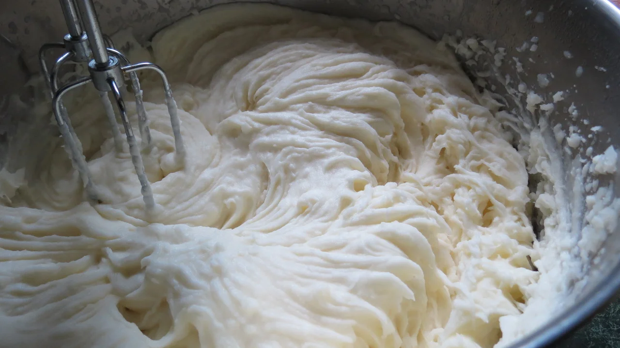 Whip potatoes until smooth and light and creamy.