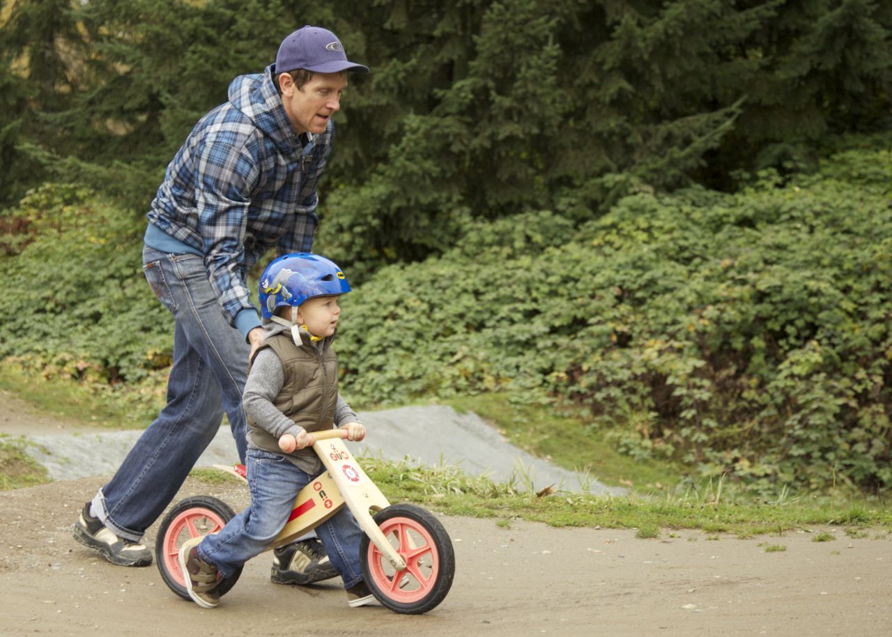Stu helping Ethan over the bumps on the bike park trail.