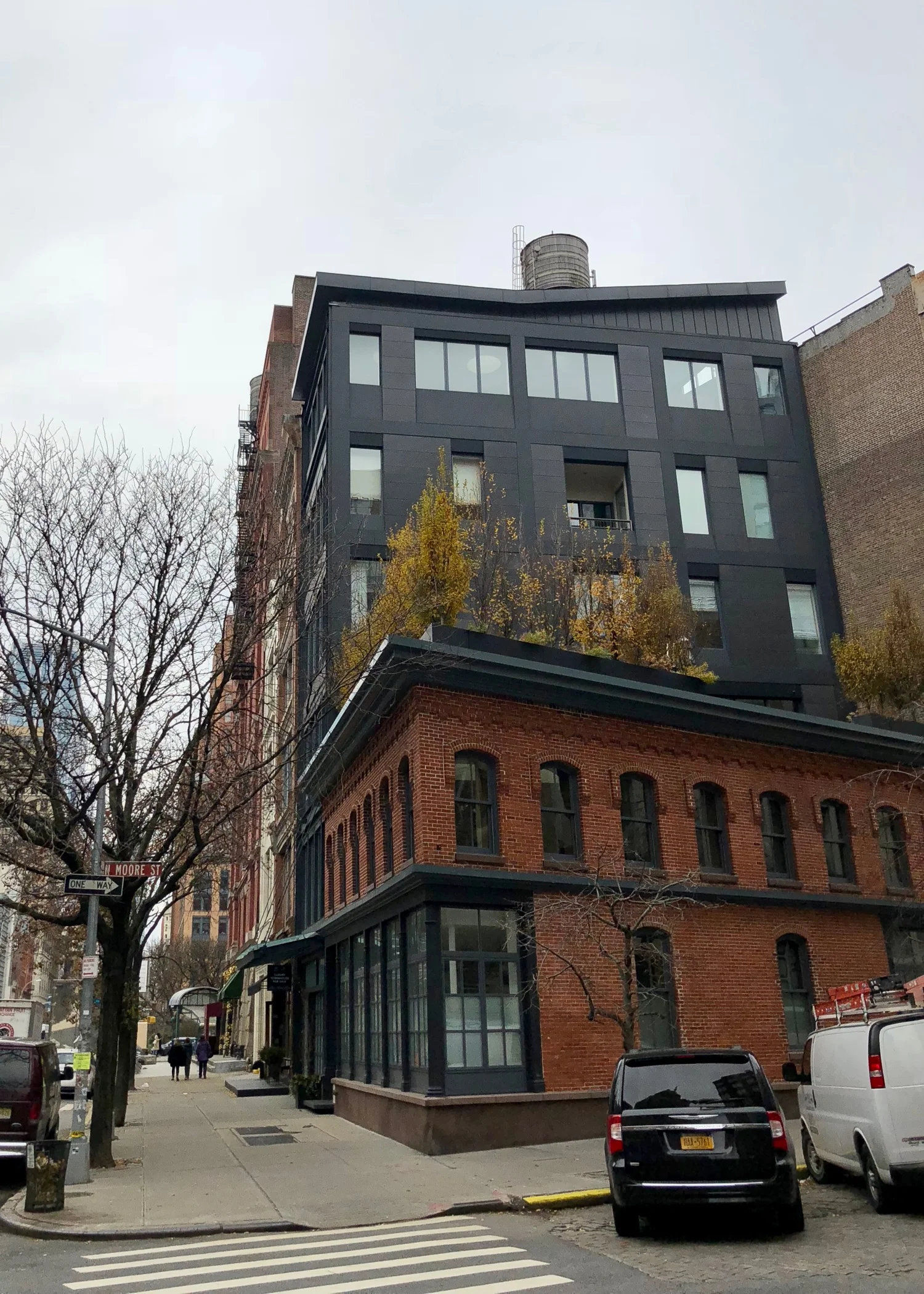 The "townhouse" is the 5 story grey building, including the roof top deck over the brick building.