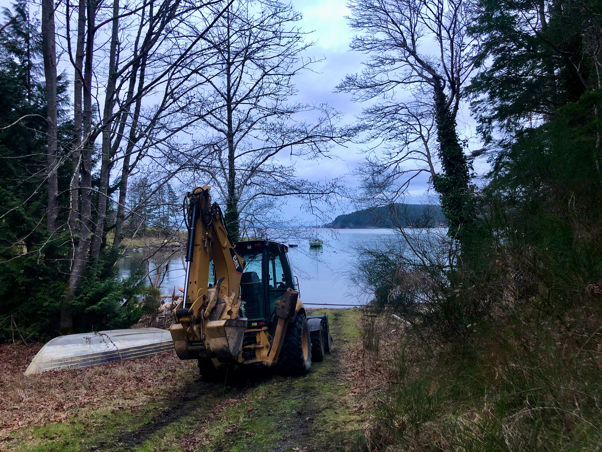  Galiano Excavating provided a backhoe to help us at the landing site. Prior to the barge arriving he did a bit of clean up to clear tree branches and make the site a little better.  We ended up really needing it… 