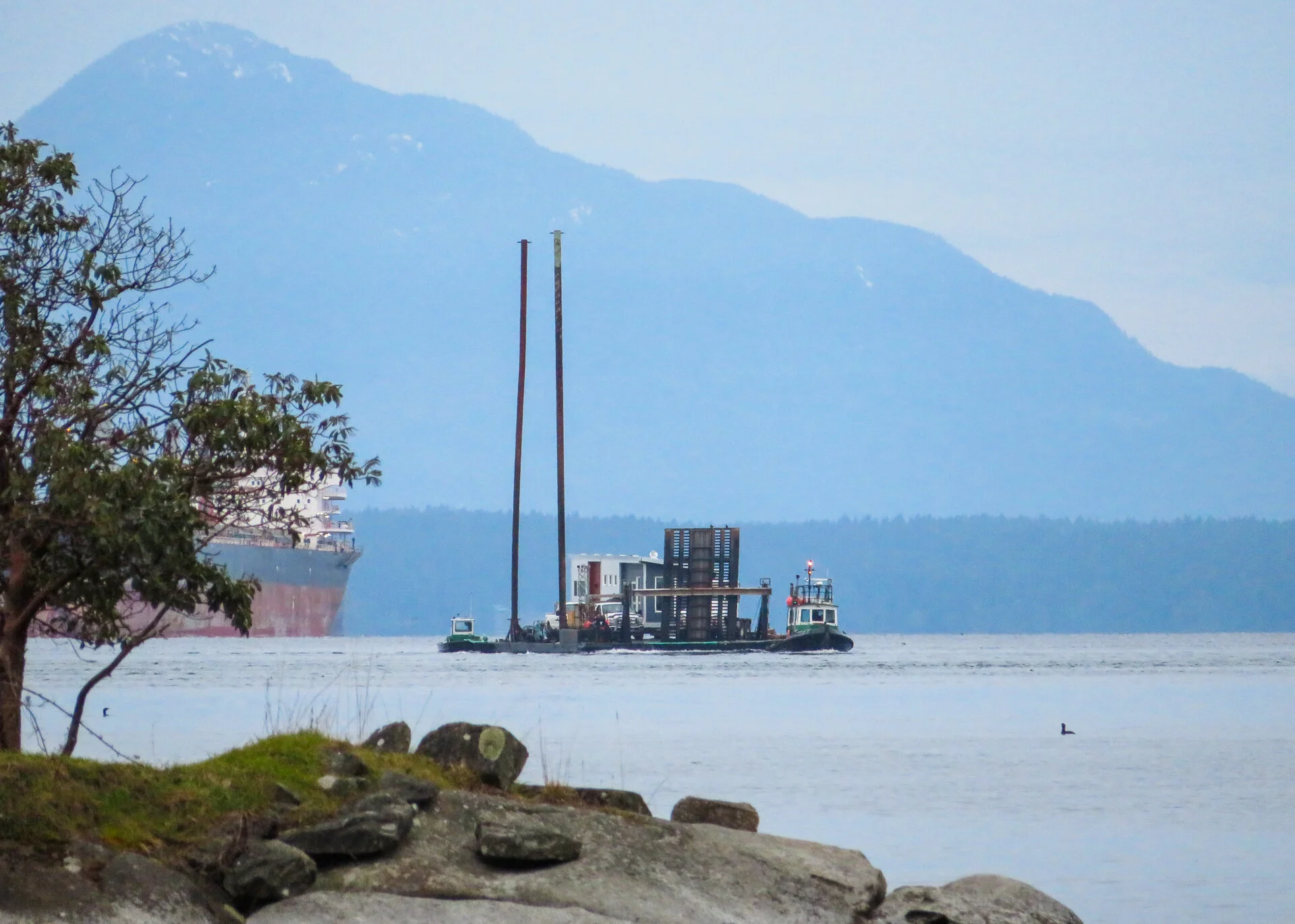  We were confused by the huge poles on the barge. As it turned out, they used them to anchor the barge in the ground once they hit land. They provide stabilization as they offload. 