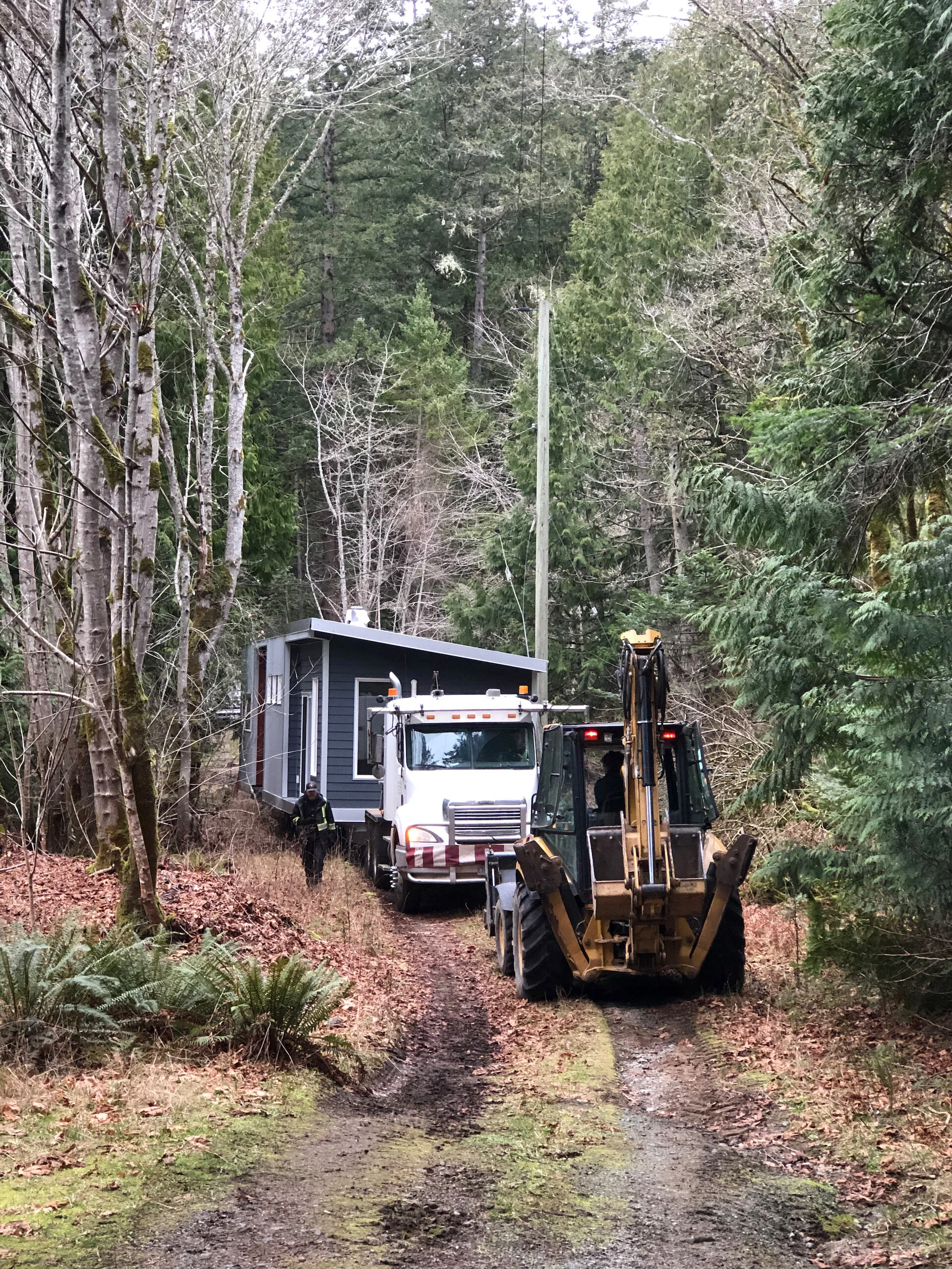  The backhoe helped tow the truck and cottage quite a ways up the lane to the main road. 
