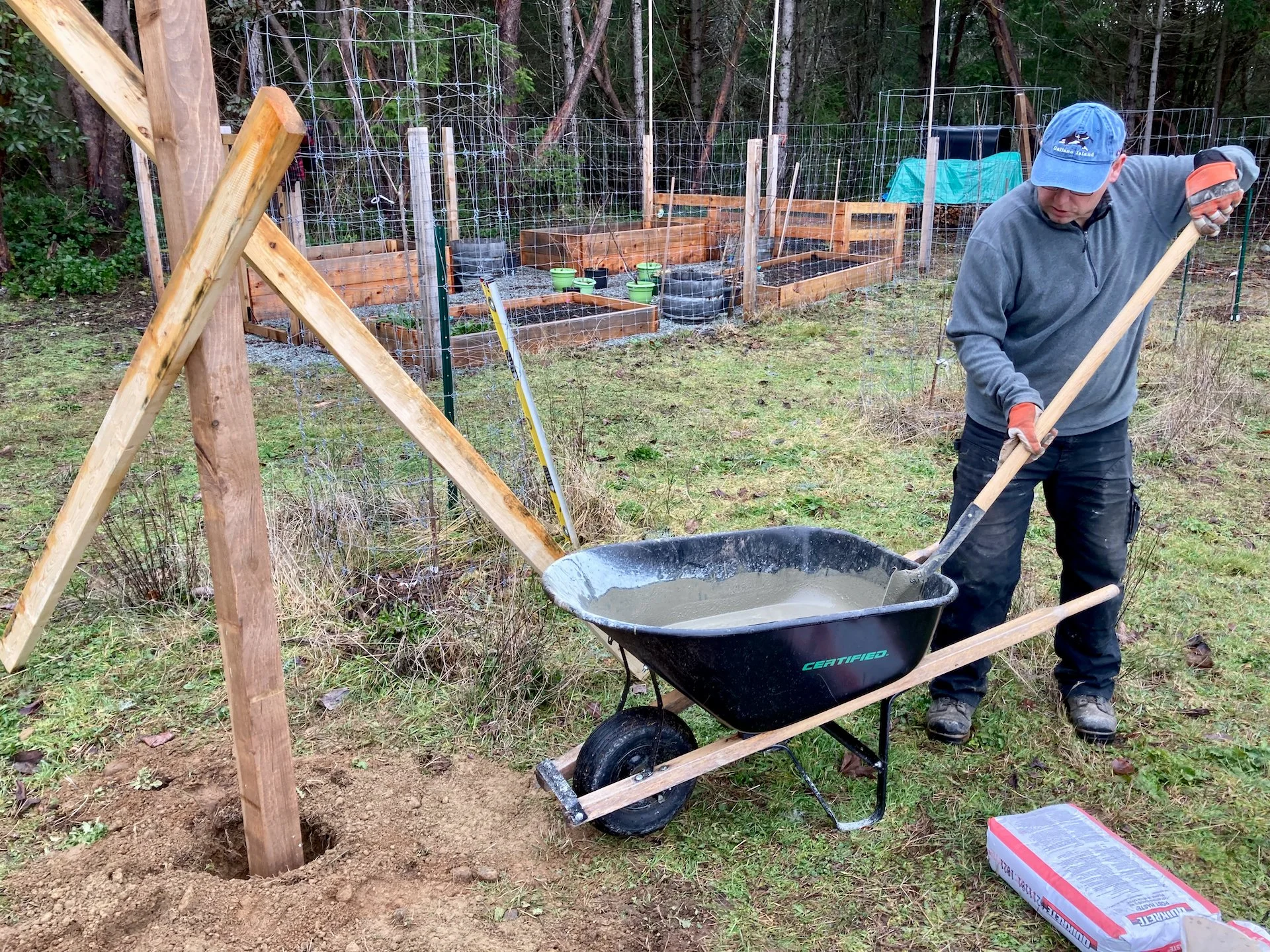  Working the cement for our first post. 