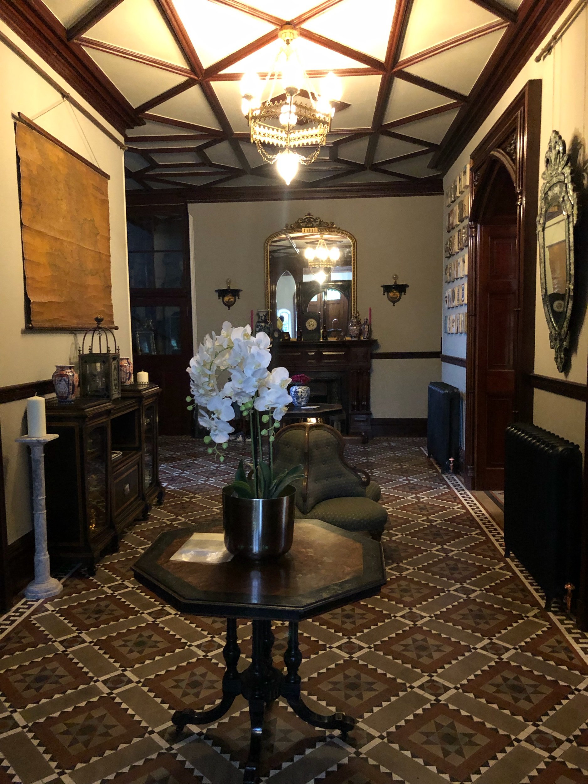  The front hall off the main entrance. The stone tile floor is just spectacular, and the carved wood door frames are beautiful. 
