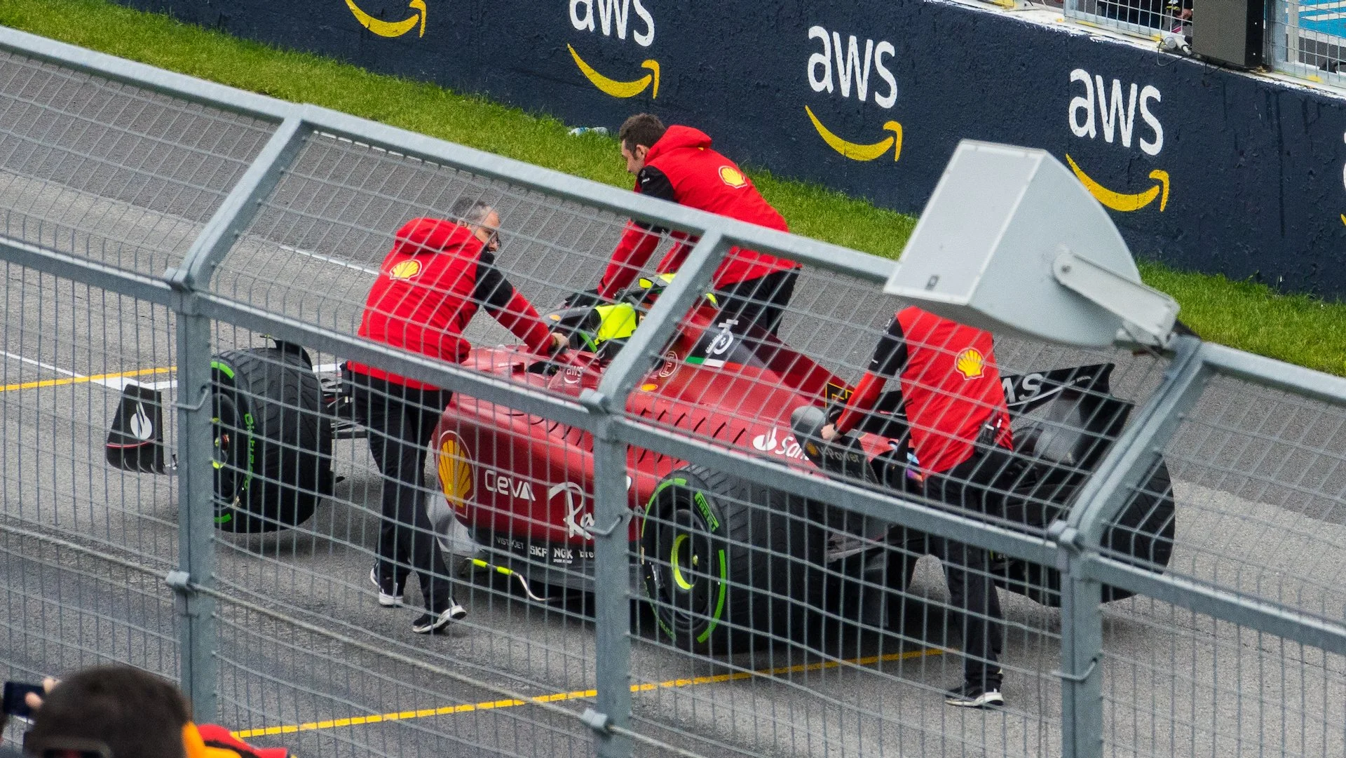  After the festivities they have to push the cars all the way back down to the start of the pit lane and into the garages.  