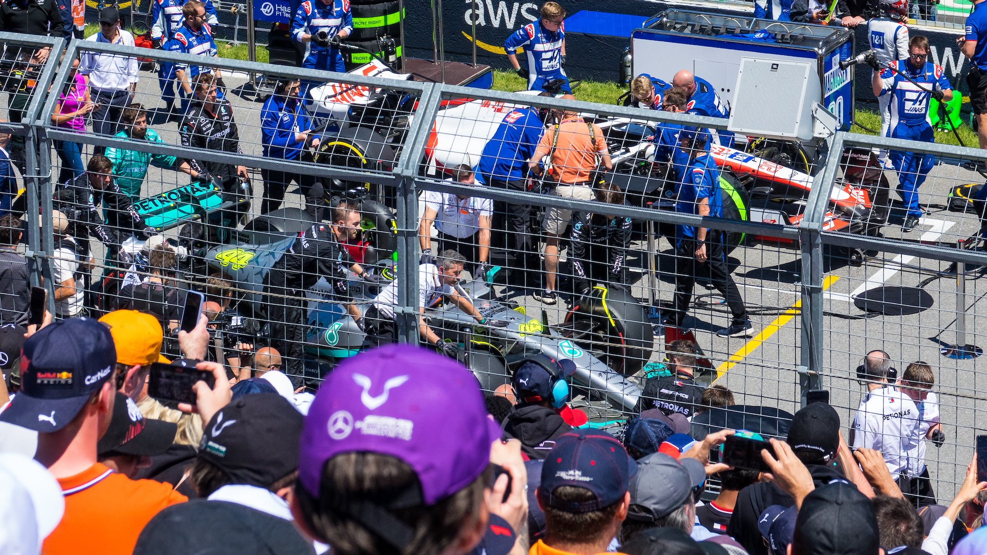 Pushing Hamilton's car up to it's grid spot.