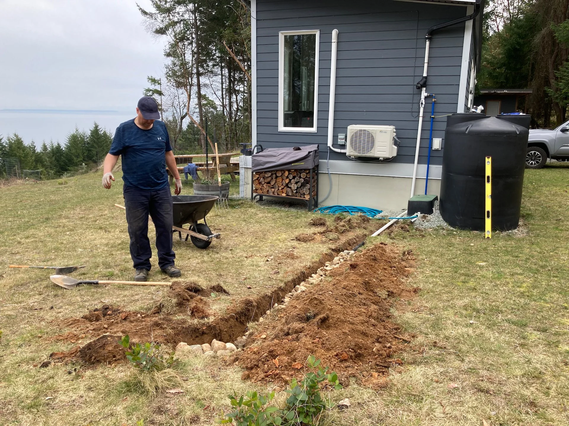  Once the trench was dug, we laid the pipe and then lined it all with rocks.  