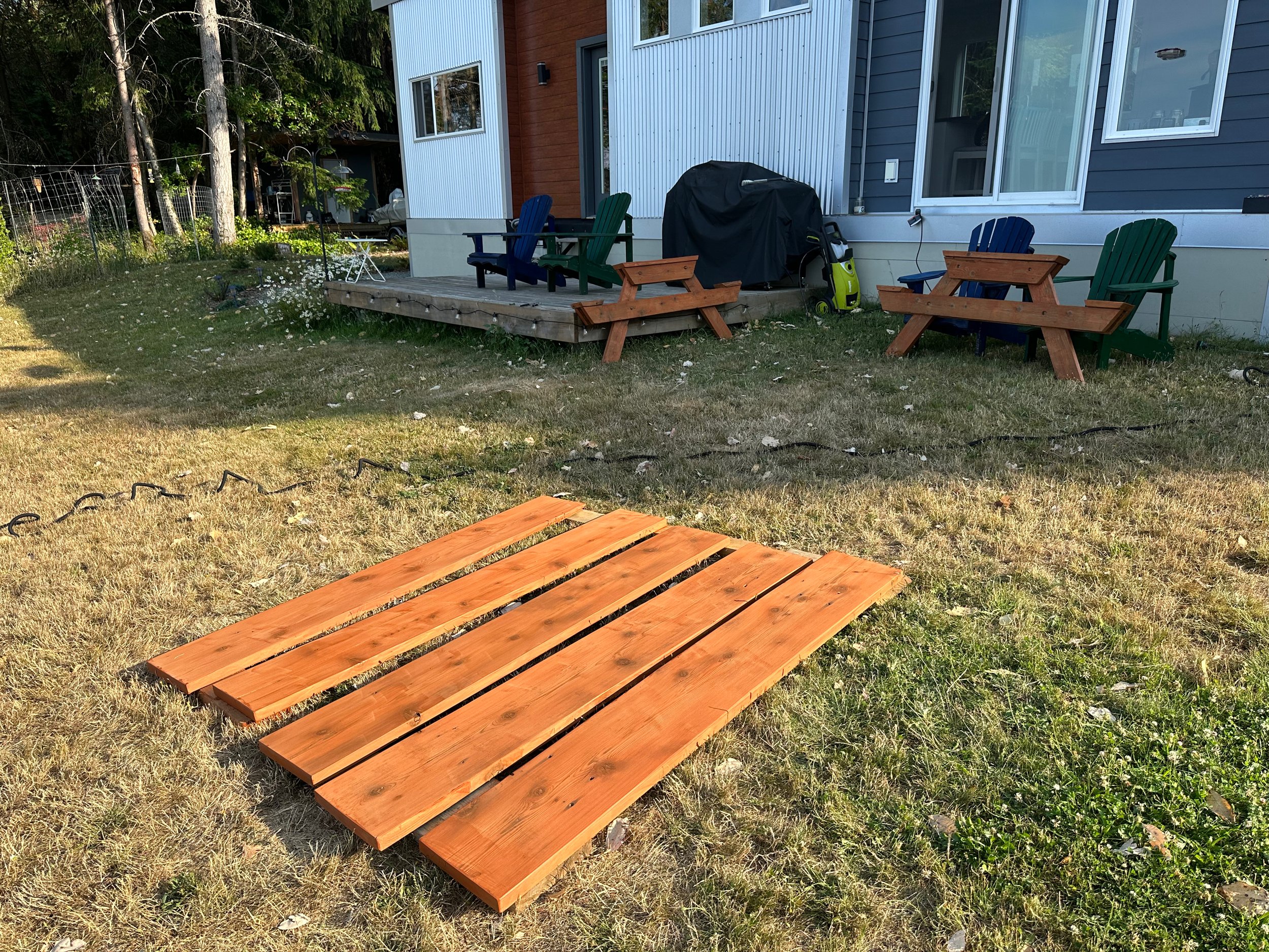  And then the next day, everything got a new coat of stain. Simon would be disappointed with my fine finishing skills (it’s not the most beautiful staining job ever), but it works for a picnic table.  
