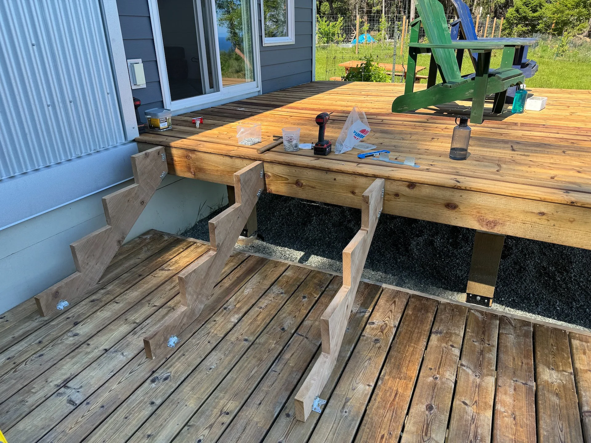  Of the two projects, the deck was definitely the easiest. We had bought pre-cut stringers, so it was a matter of some small adjustments for height, getting them hung and adding deck boards.  