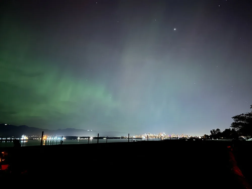  Looking back over the city, you can see the light pollution just dilute the auroras.   