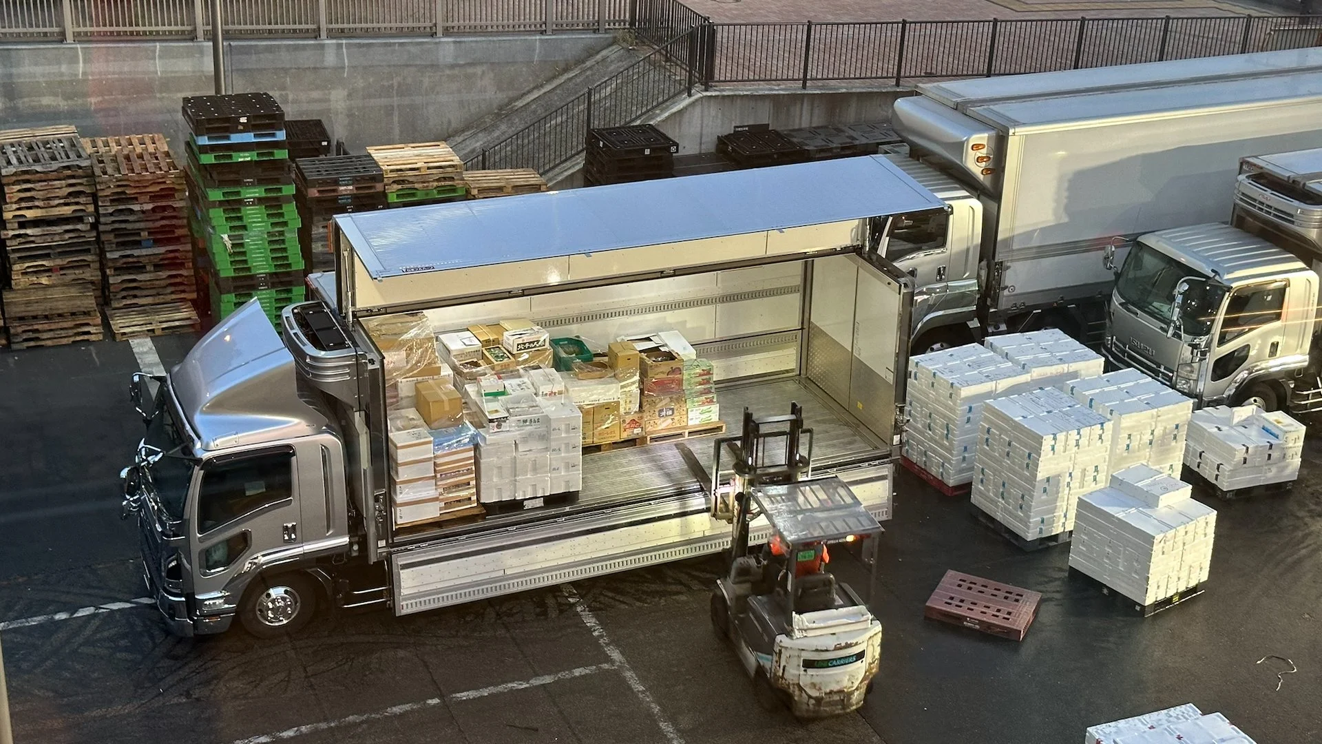  As we were walking through the halls connecting the parts of the market, we could see down into one of the loading areas. I thought these trucks were cool - the side opening would make it so much more efficient to load and unload.  