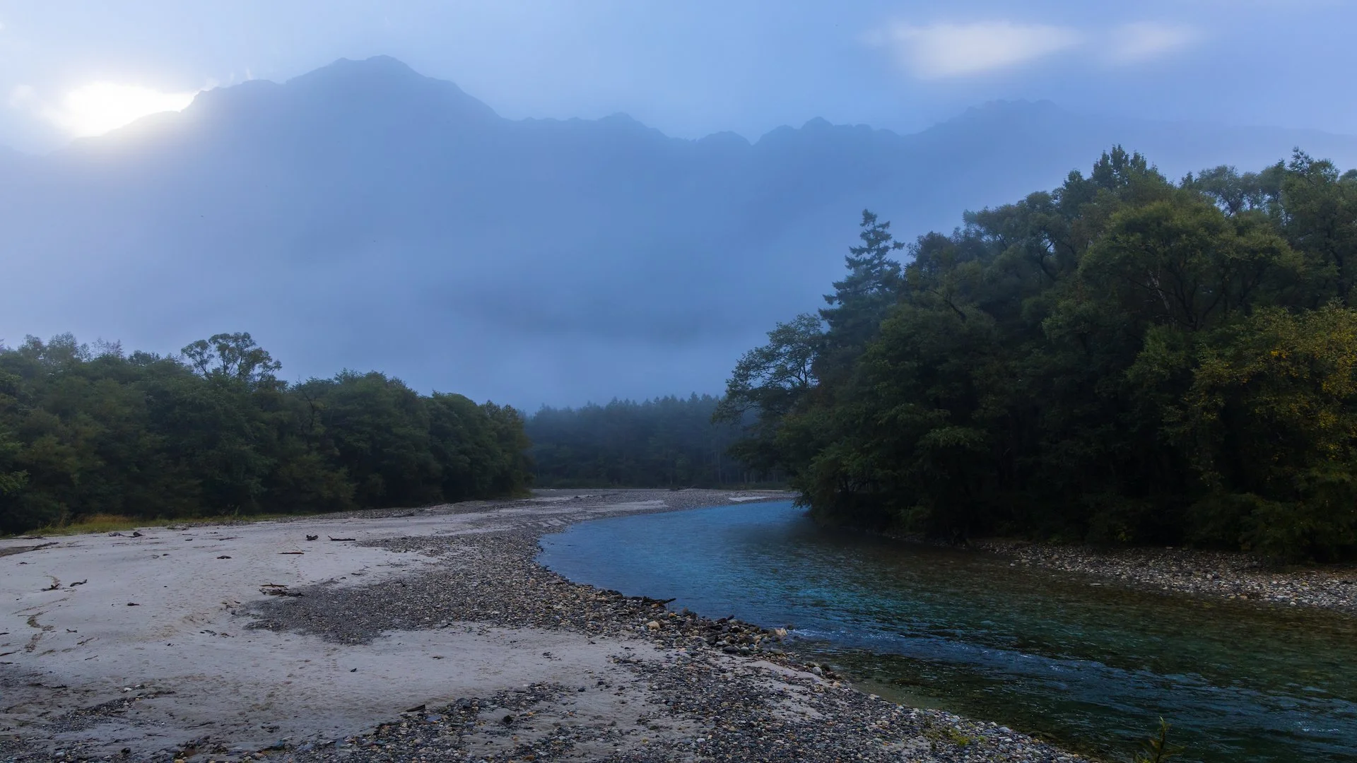  As we continued downstream, the surrounding mountains started to appear out of the clouds. 