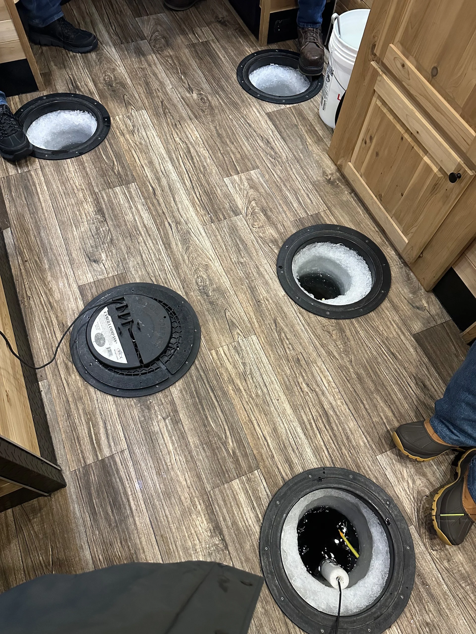  There were 6-7 holes cut int he ice, allowing for many people to give it a try. 