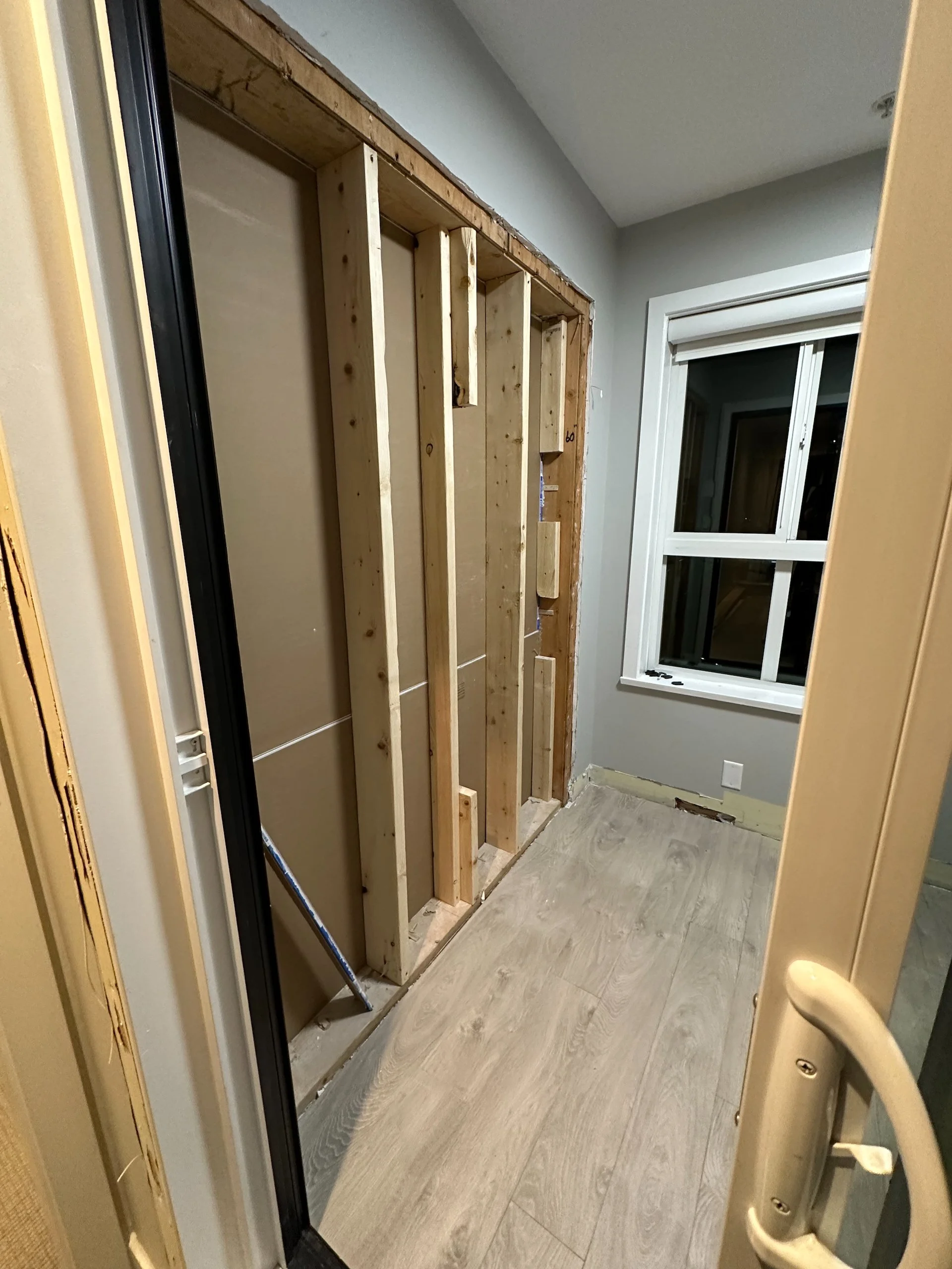  After removing the sliding glass doors, they had to frame in new walls. This is the wall between the office and bedroom. 