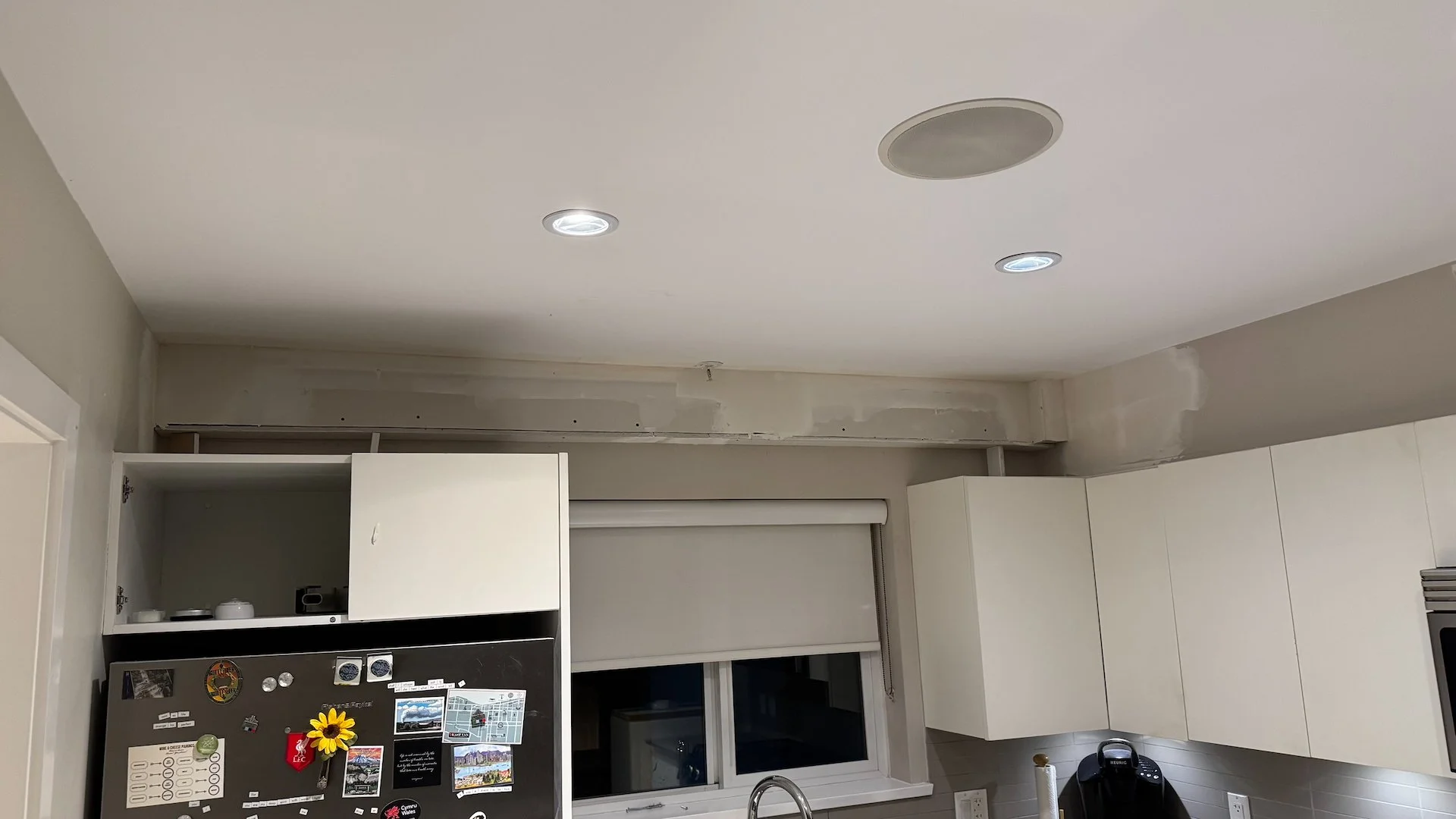  The heat pump plumbing and electrical had to run along the full width of the kitchen. They built a box with drywall to hide it all. 