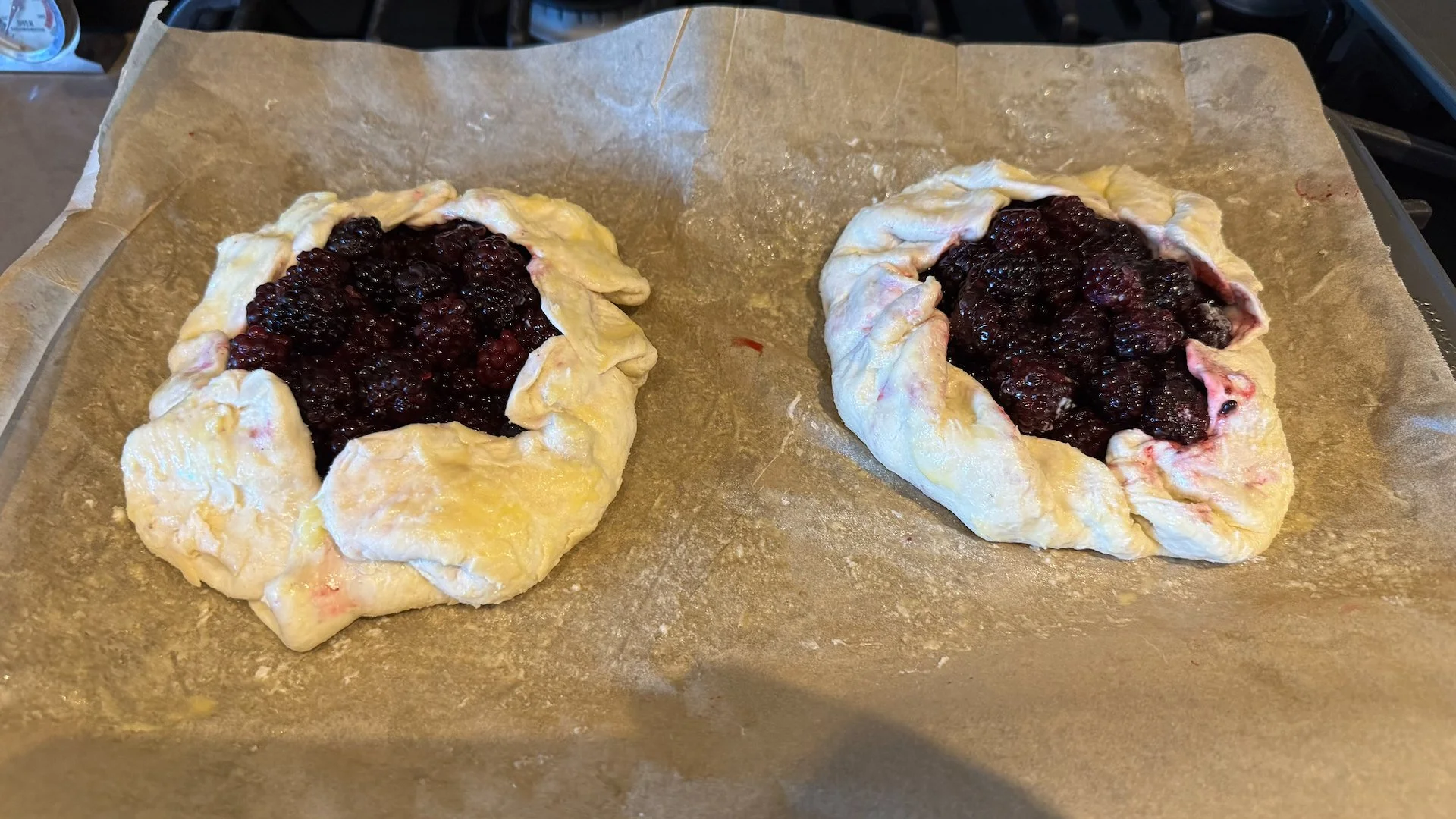  With some of the blackberries we harvested, Justine pulled out the baker’s apron and made these beauties! 