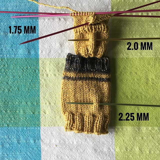 Swatching for socks and taking a photo to keep track of needle sizes. Dark blue yarn is Malabrigo Sock in colorway 871 Playa, gold is Spud &amp; Chlo&euml; Fine, originally color Popcorn and then dyed with dried pomegranate rinds.