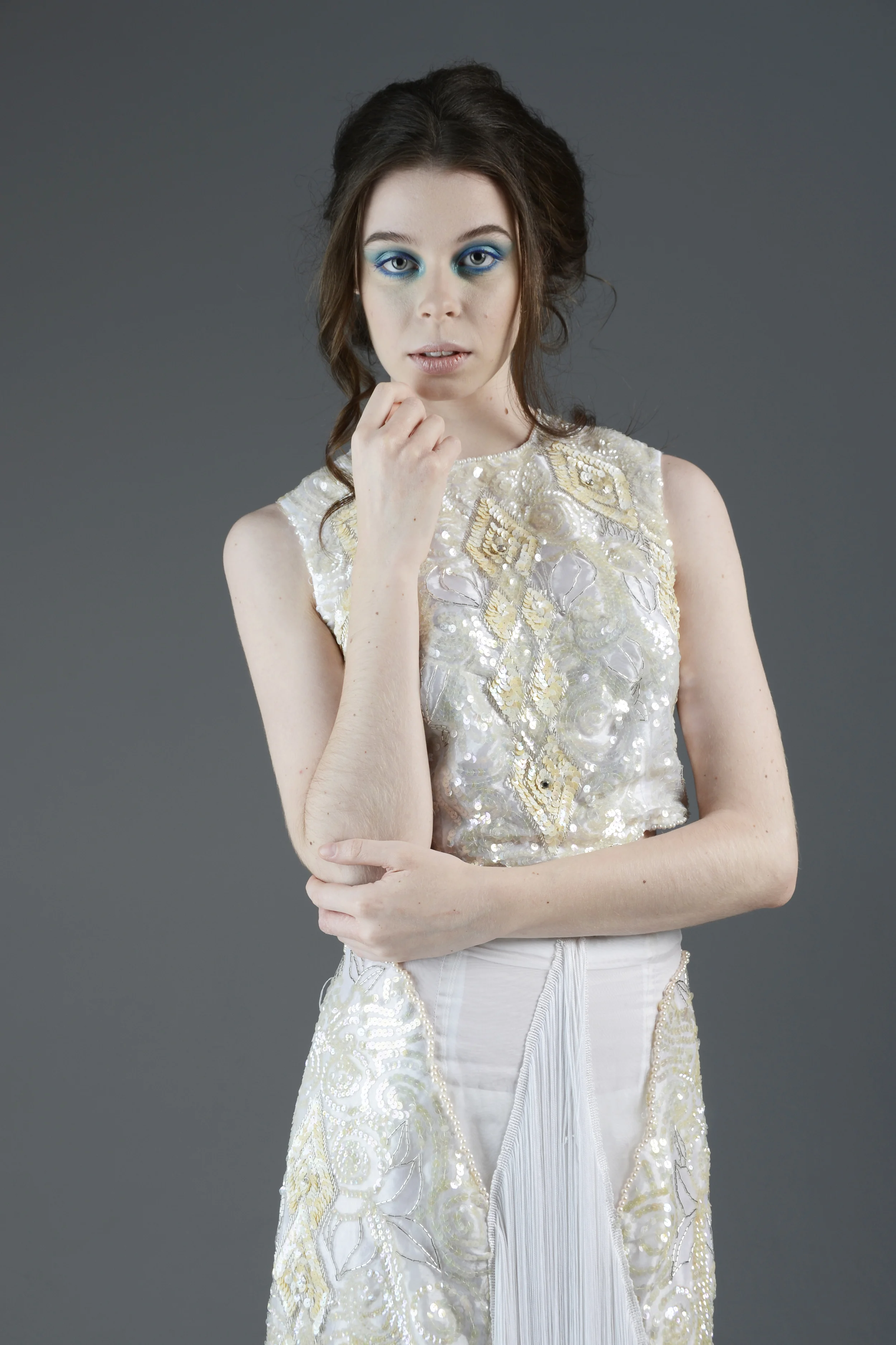 Markana is wearing a two piece sequin embroidered gown with fringe skirt detail. 