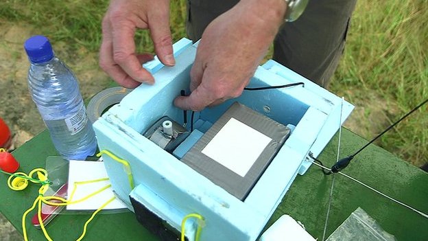 Preparing the insulated instrument module in the Malawi countryside (Source: BBC)